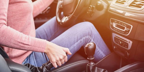 Female,Hand,Pulling,Handbrake,In,The,Car.,Woman,Driving,Car